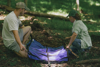 Emergency animal stretcher with hand loops that can slide sticks as poles into them.